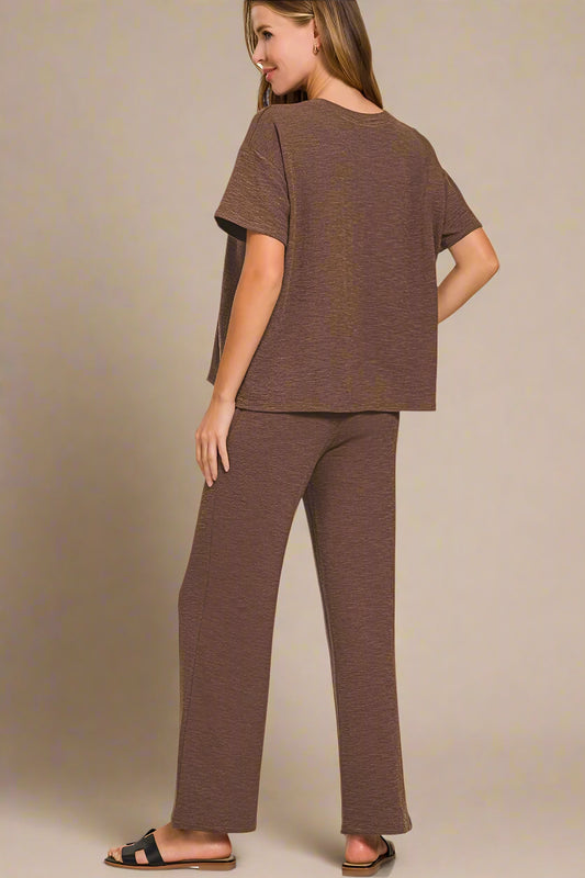 Woman wearing a brown outfit on a white background