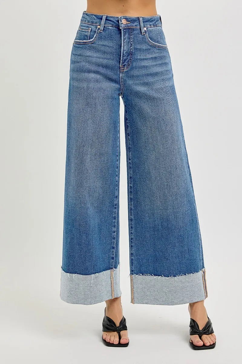 Wide-leg blue jeans on a white background