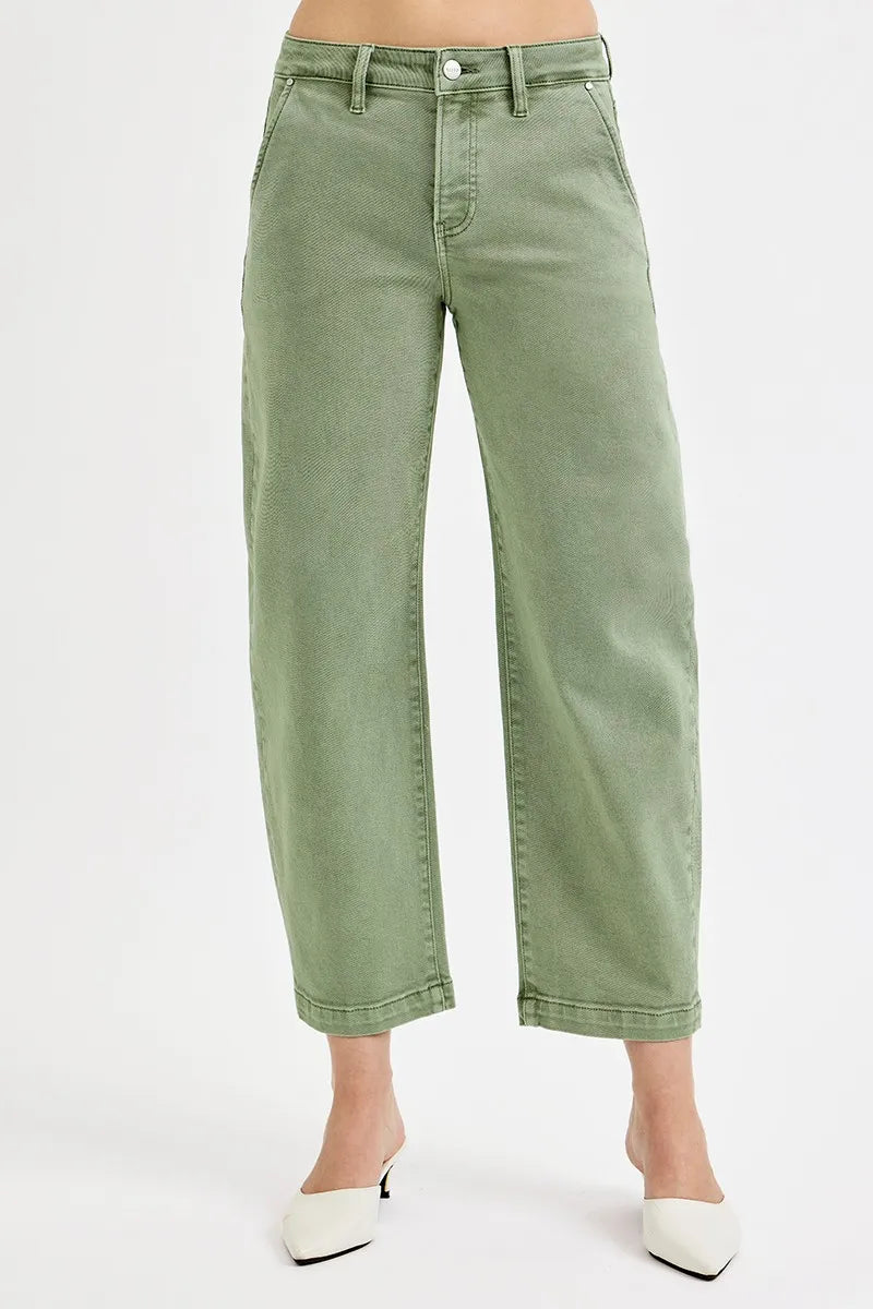 Green jeans worn by a person on a white background
