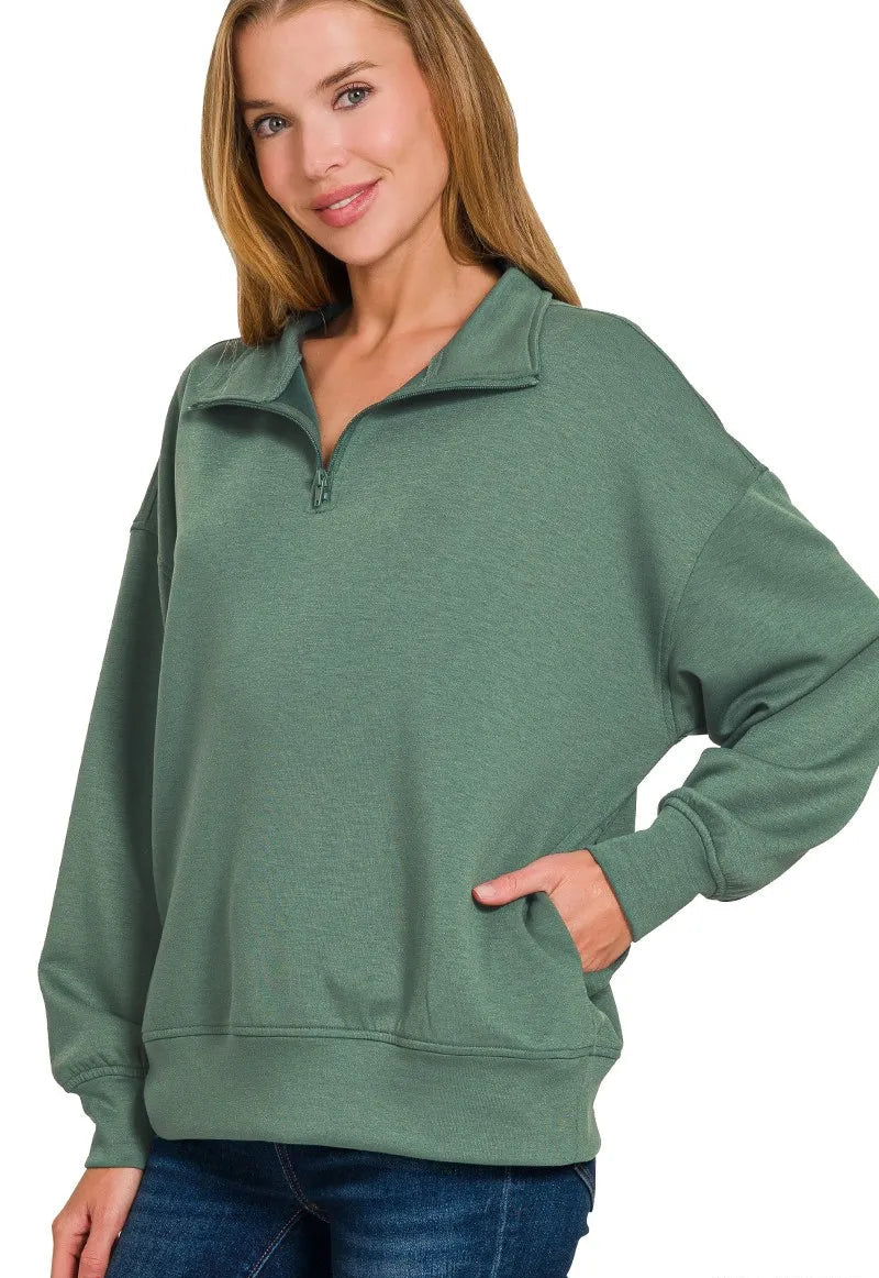 Woman wearing a green pullover with a white background