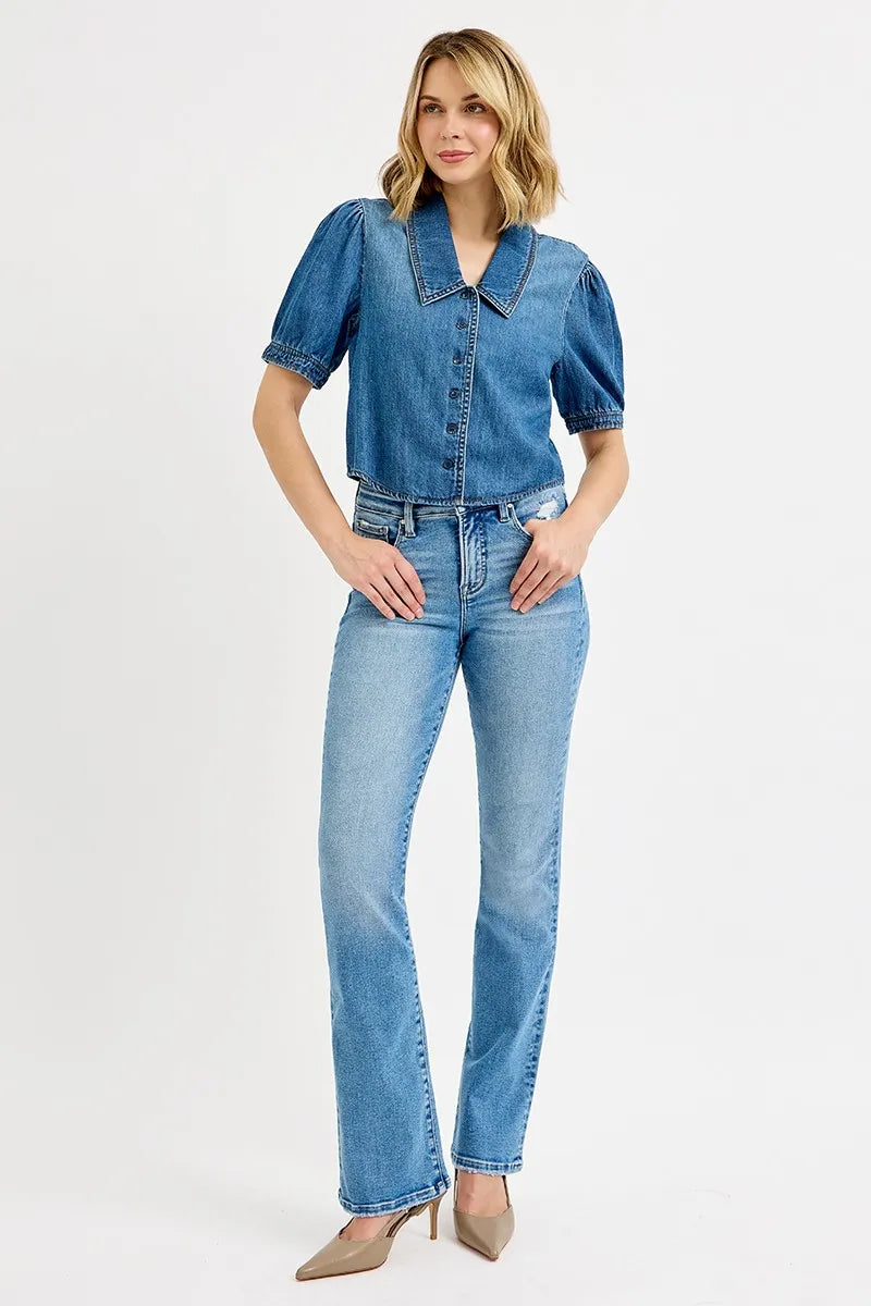 Woman wearing a denim outfit on a white background