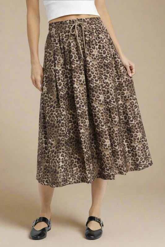 Person wearing a leopard print skirt on a white background