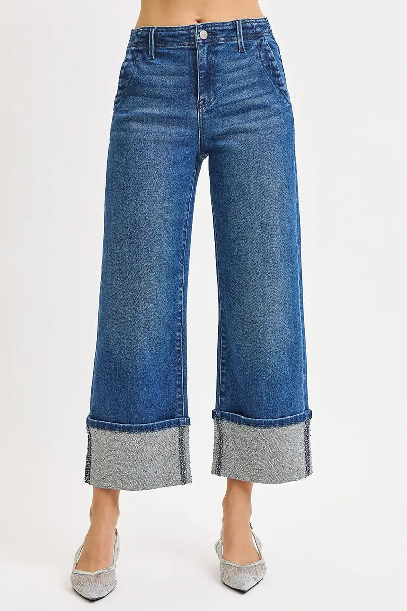 Blue wide-leg jeans with rhinestone cuffs on a white background