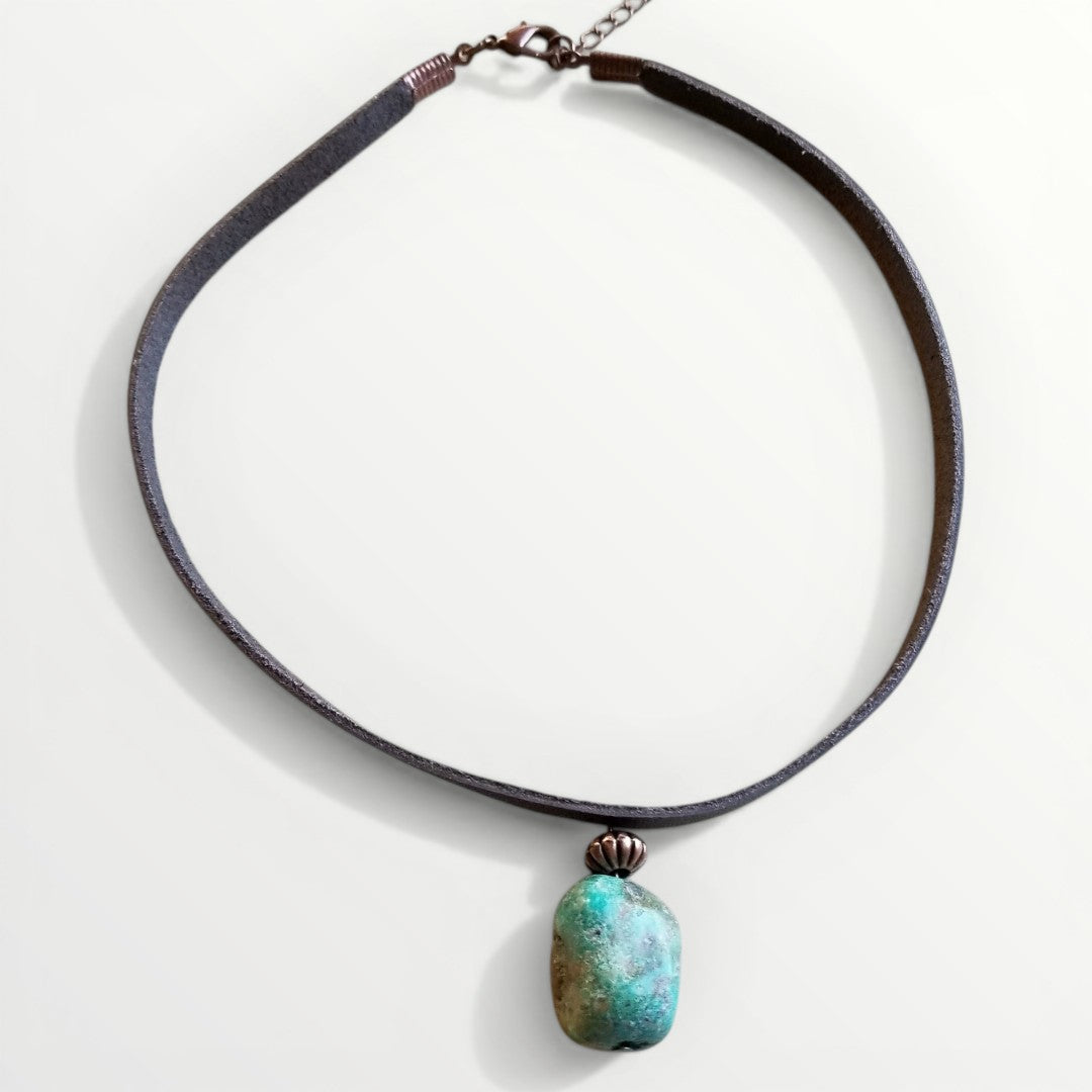 Necklace with a turquoise pendant on a white background