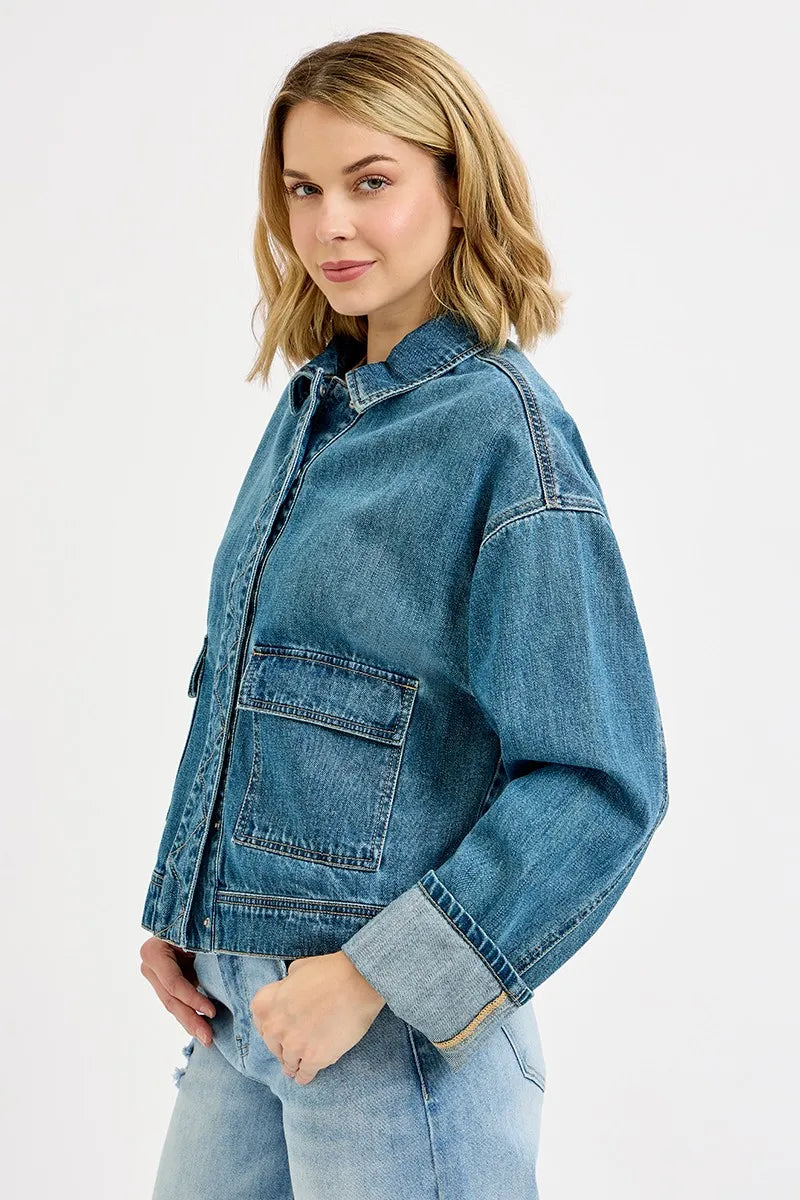 Woman wearing a blue denim jacket on a white background