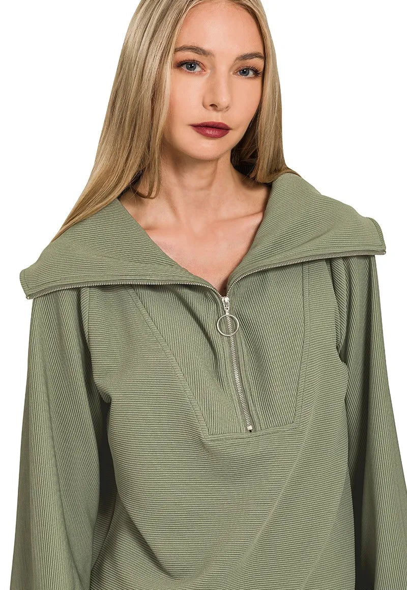 Woman wearing a green hooded garment with a zipper on a white background