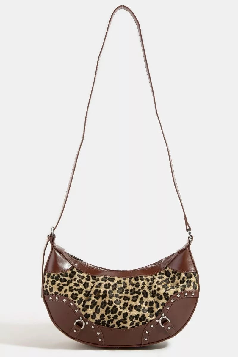 Brown handbag with leopard print accent on a white background