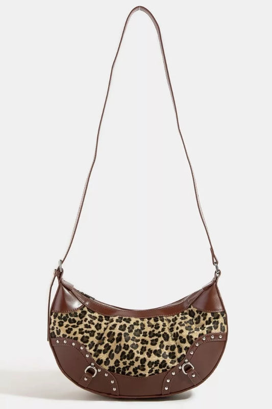 Brown handbag with leopard print accent on a white background