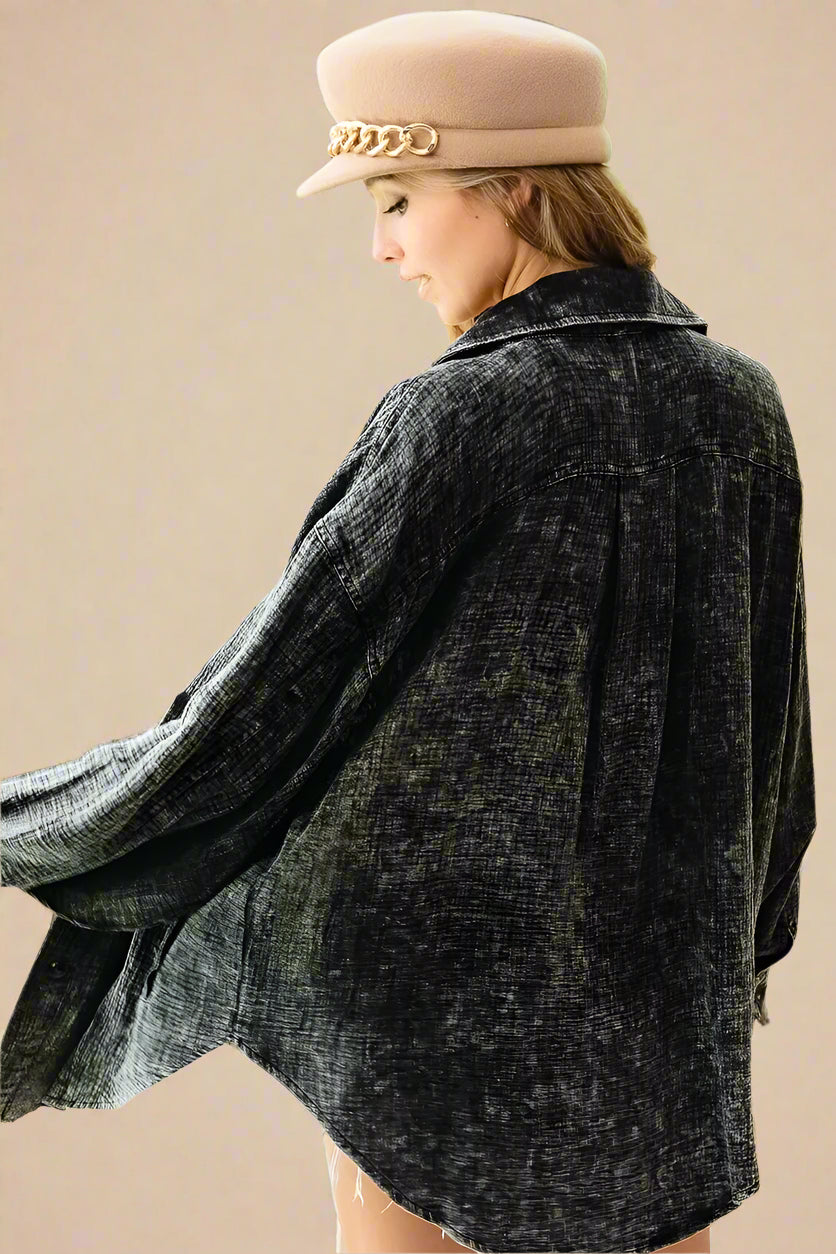 Person wearing a black jacket and beige hat