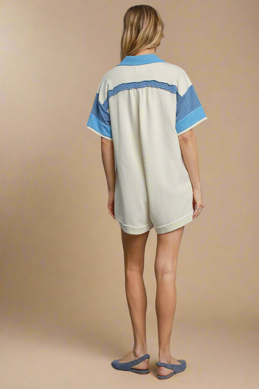 Woman wearing a white dress with blue accents on a beige background