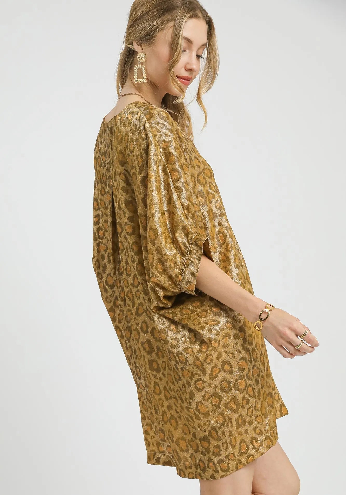 Woman wearing a leopard print dress on a white background