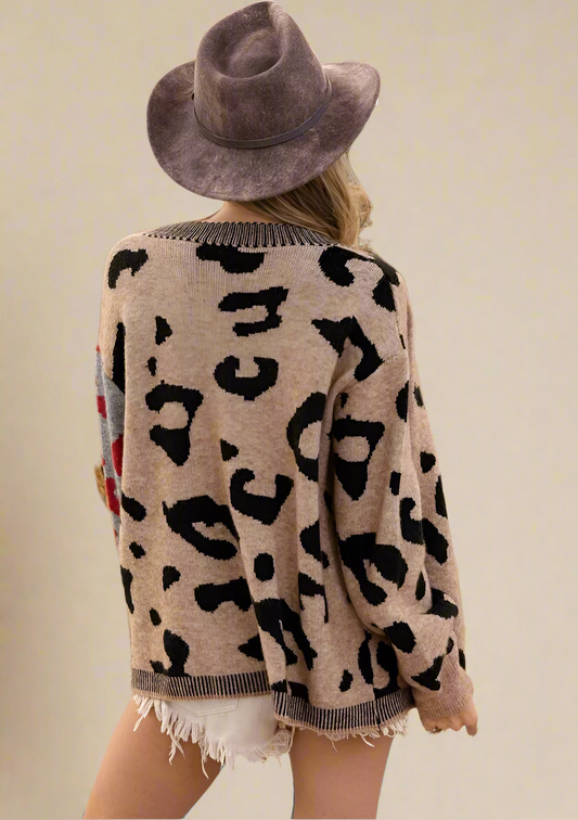 Person wearing a leopard print cardigan and brown hat on a beige background