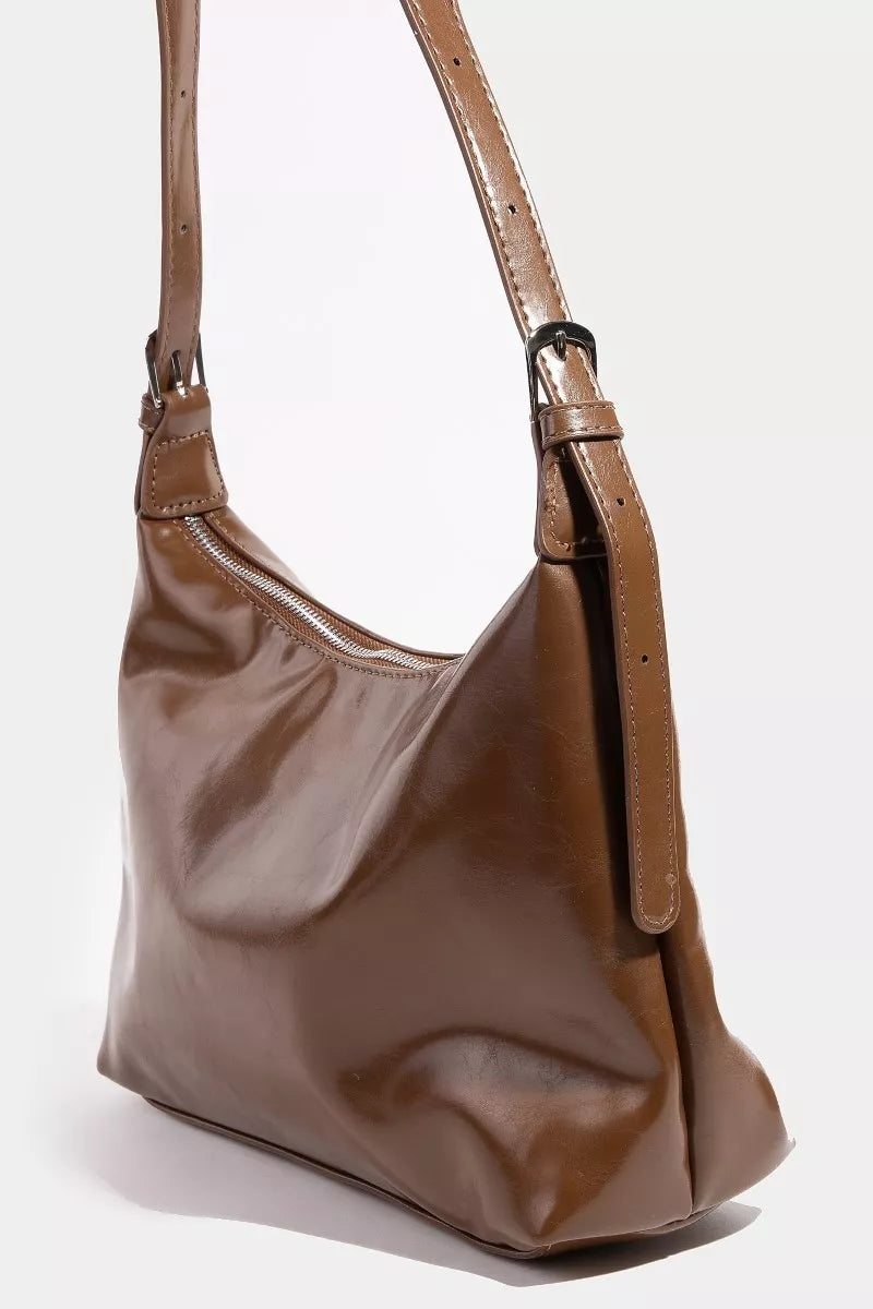 Brown leather handbag on a white background
