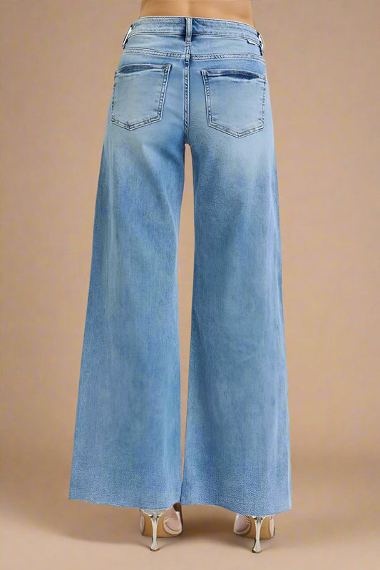 Light blue wide-leg jeans on a beige background