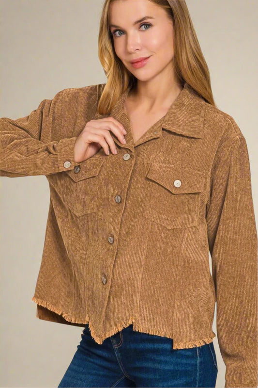 Woman wearing a brown corduroy jacket on a beige background