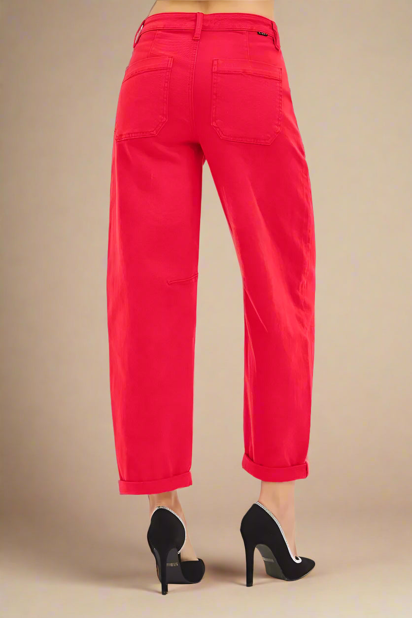 Red pants worn by a person on a white background