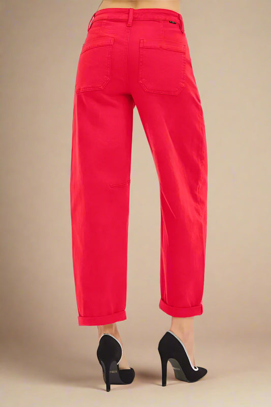 Red pants worn by a person on a white background
