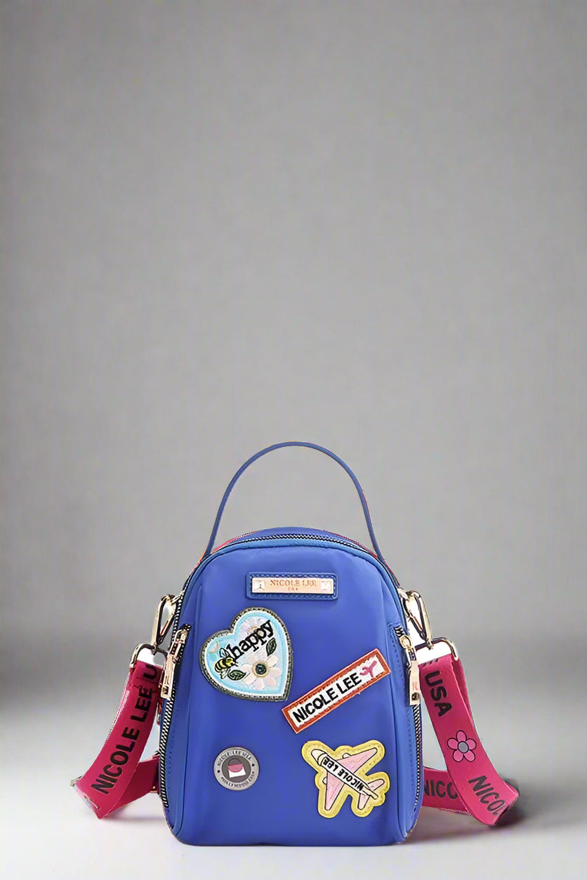 Blue bag with colorful patches and straps on a white background