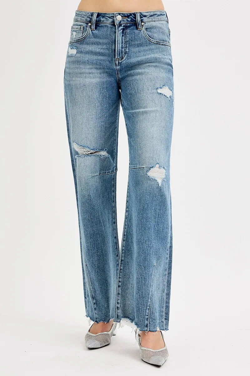 Distressed blue jeans on a white background