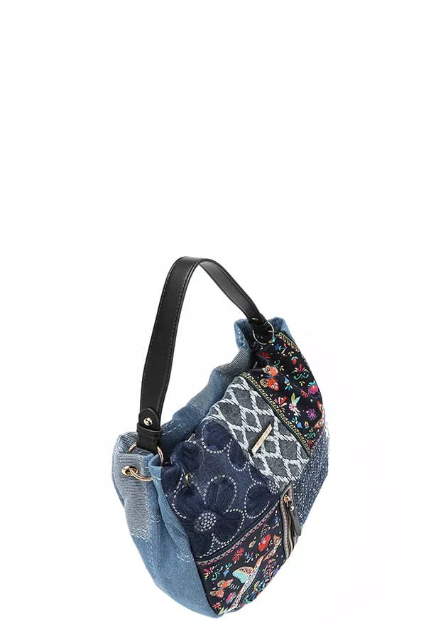 Blue patchwork handbag with floral patterns on a white background