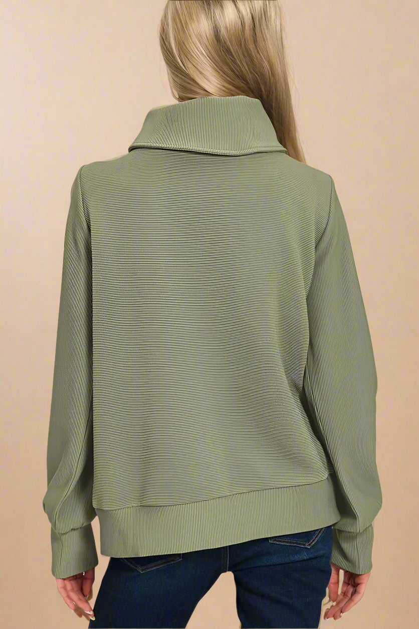 Light olive green jacket worn by a person on a white background