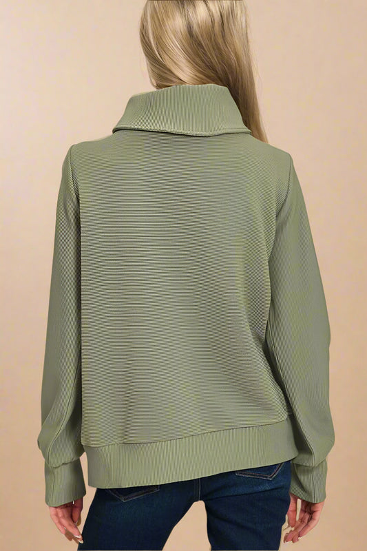 Light olive green jacket worn by a person on a white background