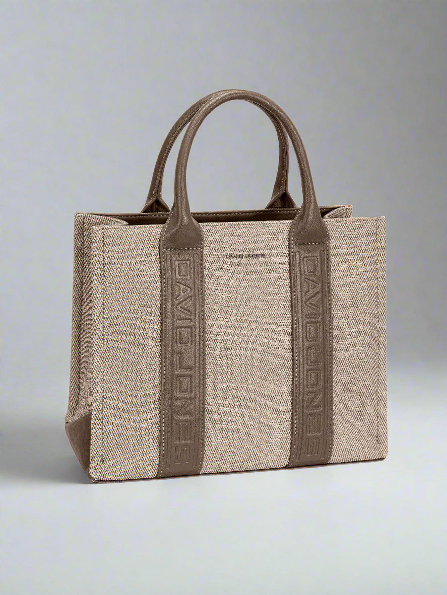 Beige handbag with brown accents on a light gray background