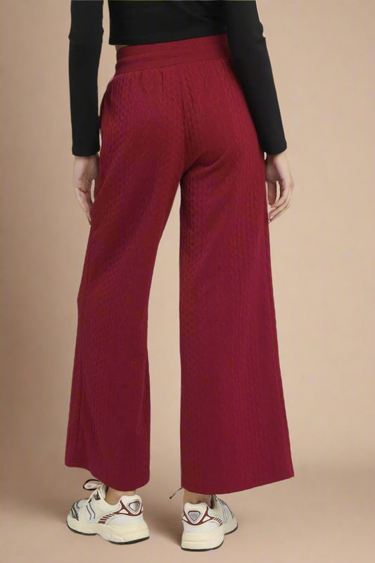 Burgundy wide-leg pants worn by a person on a white background