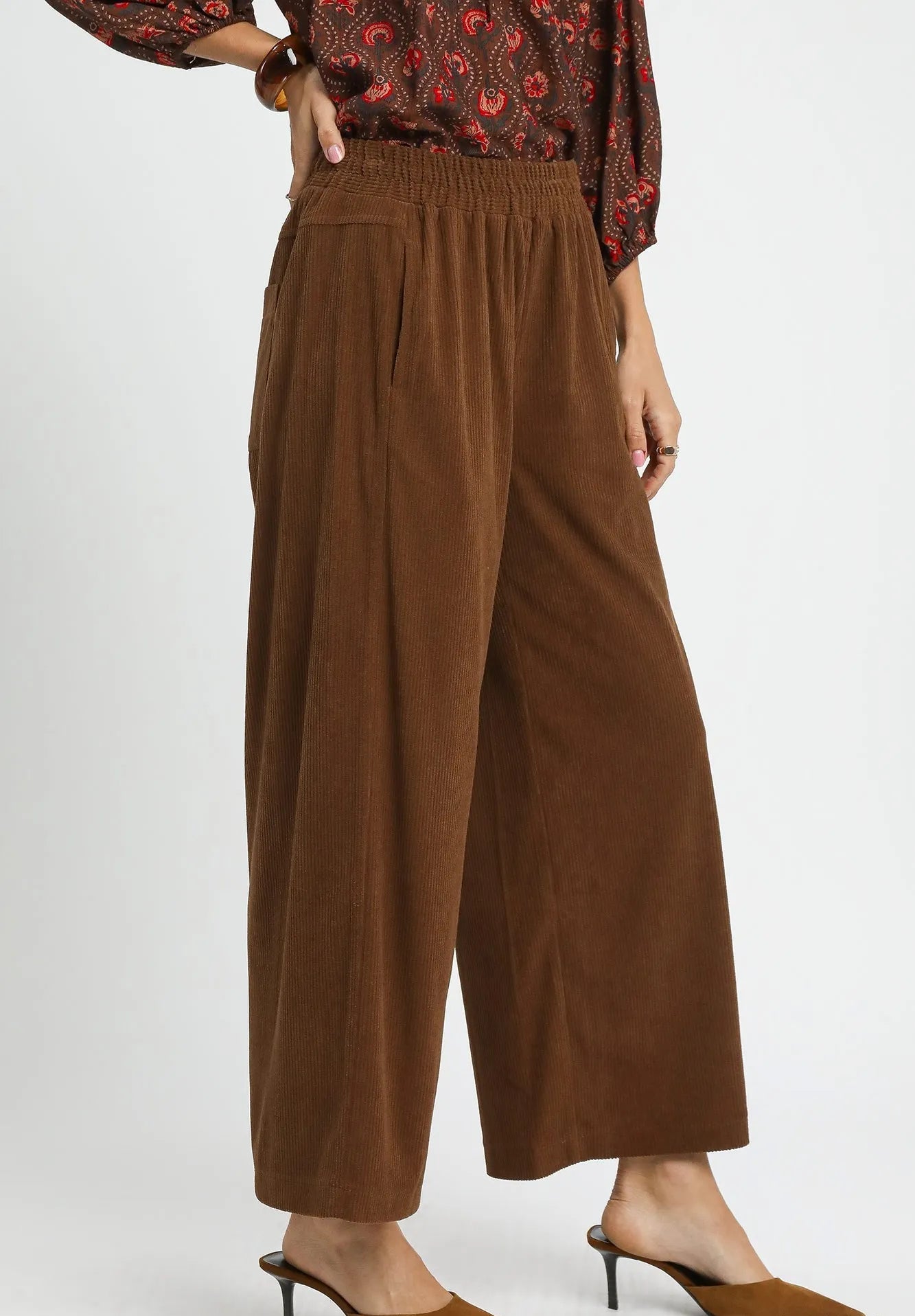Brown wide-leg pants worn by a person on a white background