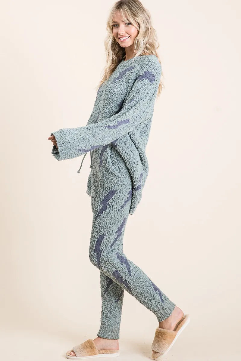 Woman wearing a blue knitted outfit on a beige background