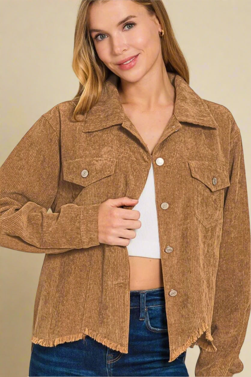 Woman wearing a brown corduroy jacket on a beige background