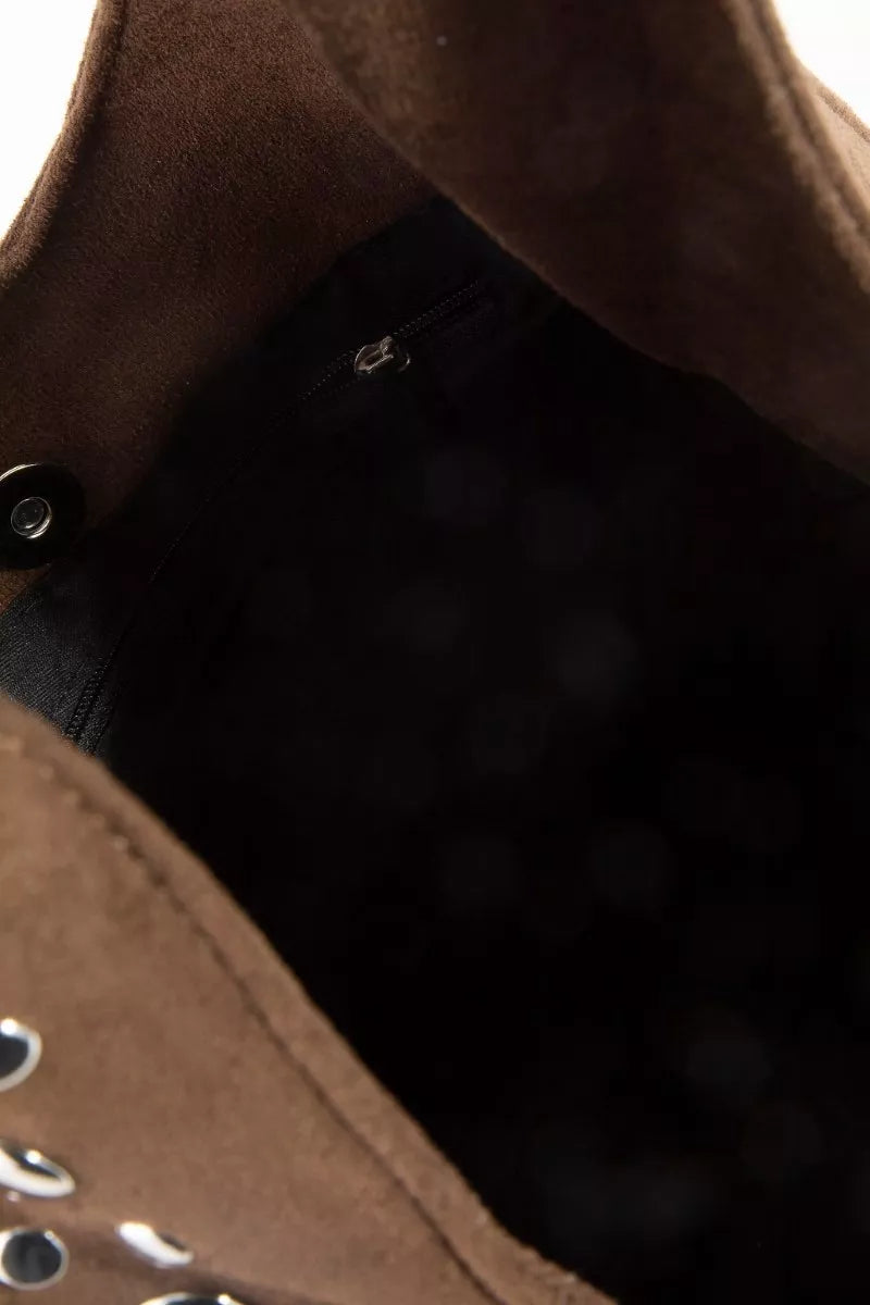 Close-up of a brown leather jacket with a zipper and button details.