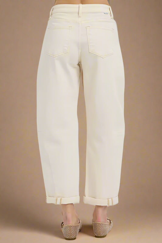 Beige jeans worn by a person on a white background