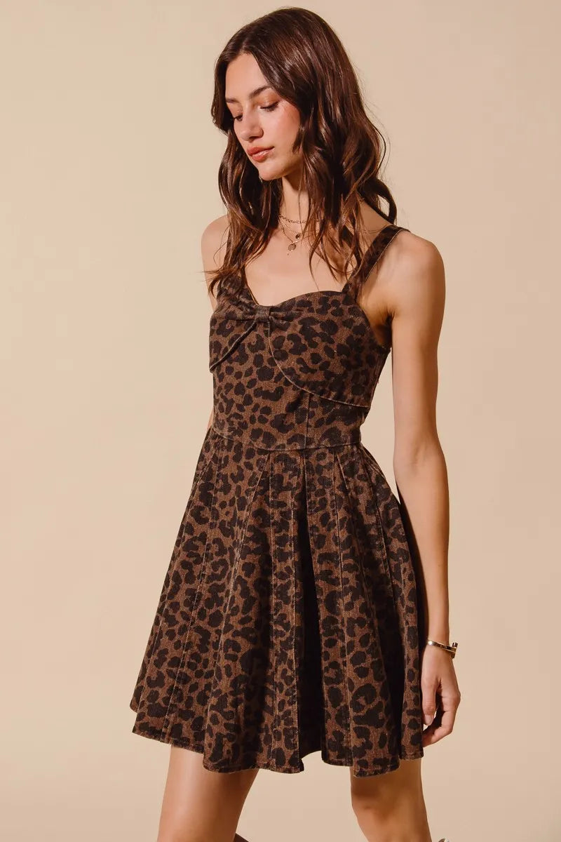 Woman wearing a leopard print dress against a beige background