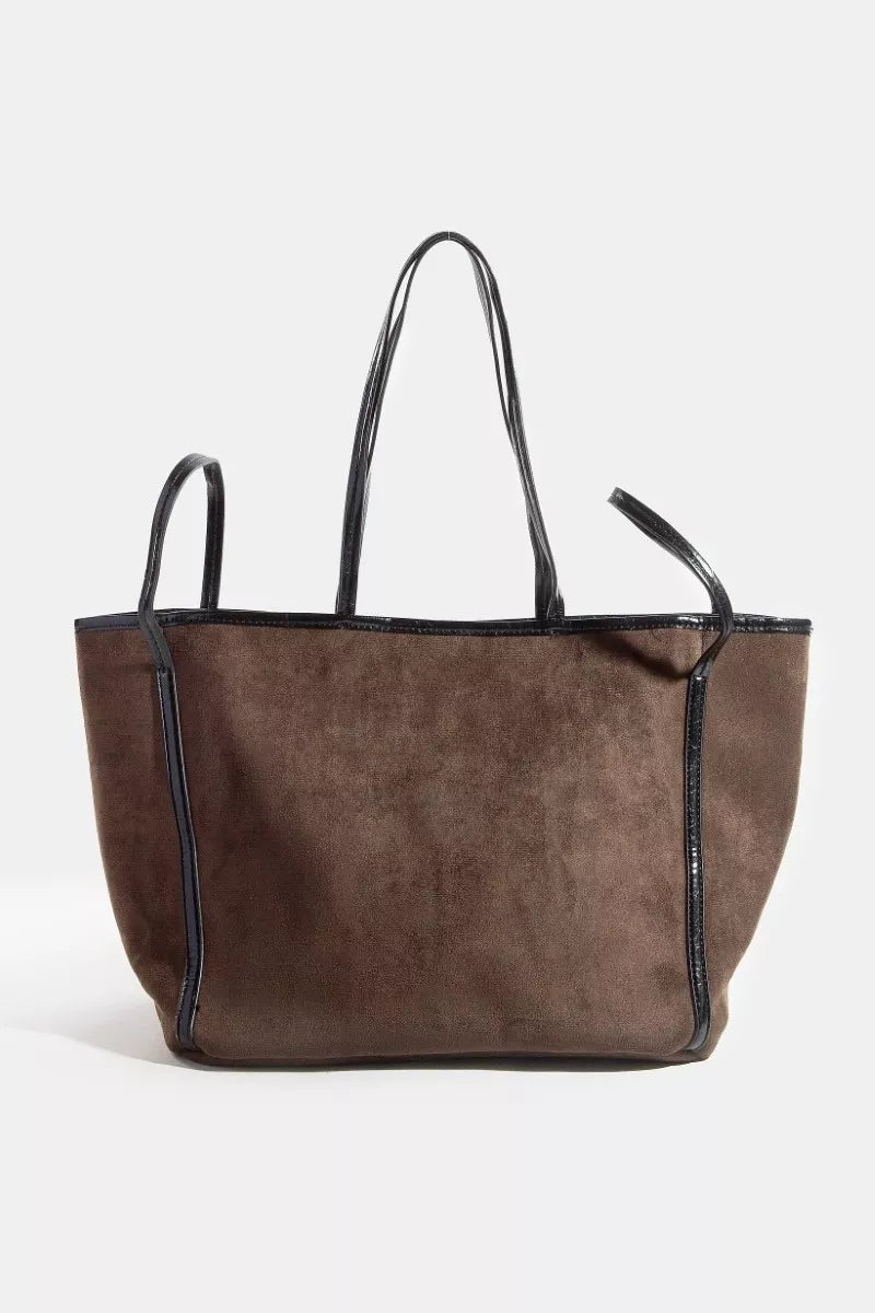 Brown suede tote bag with black accents on a white background