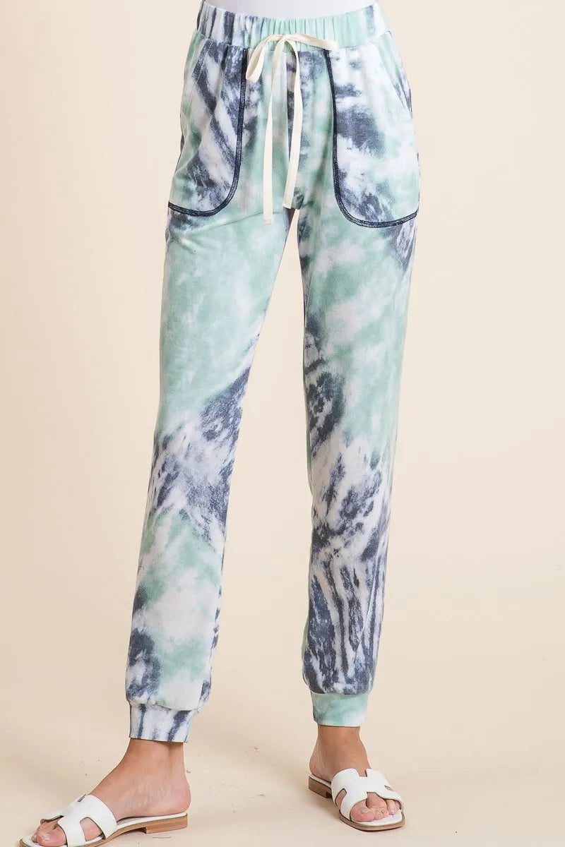 Tie-dye jogger pants with a drawstring on a beige background