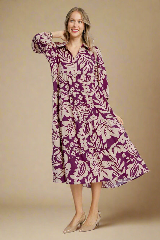Woman wearing a purple floral dress on a beige background