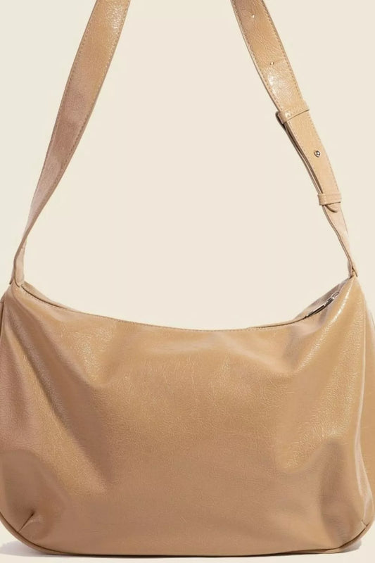 Beige handbag with a strap on a beige background
