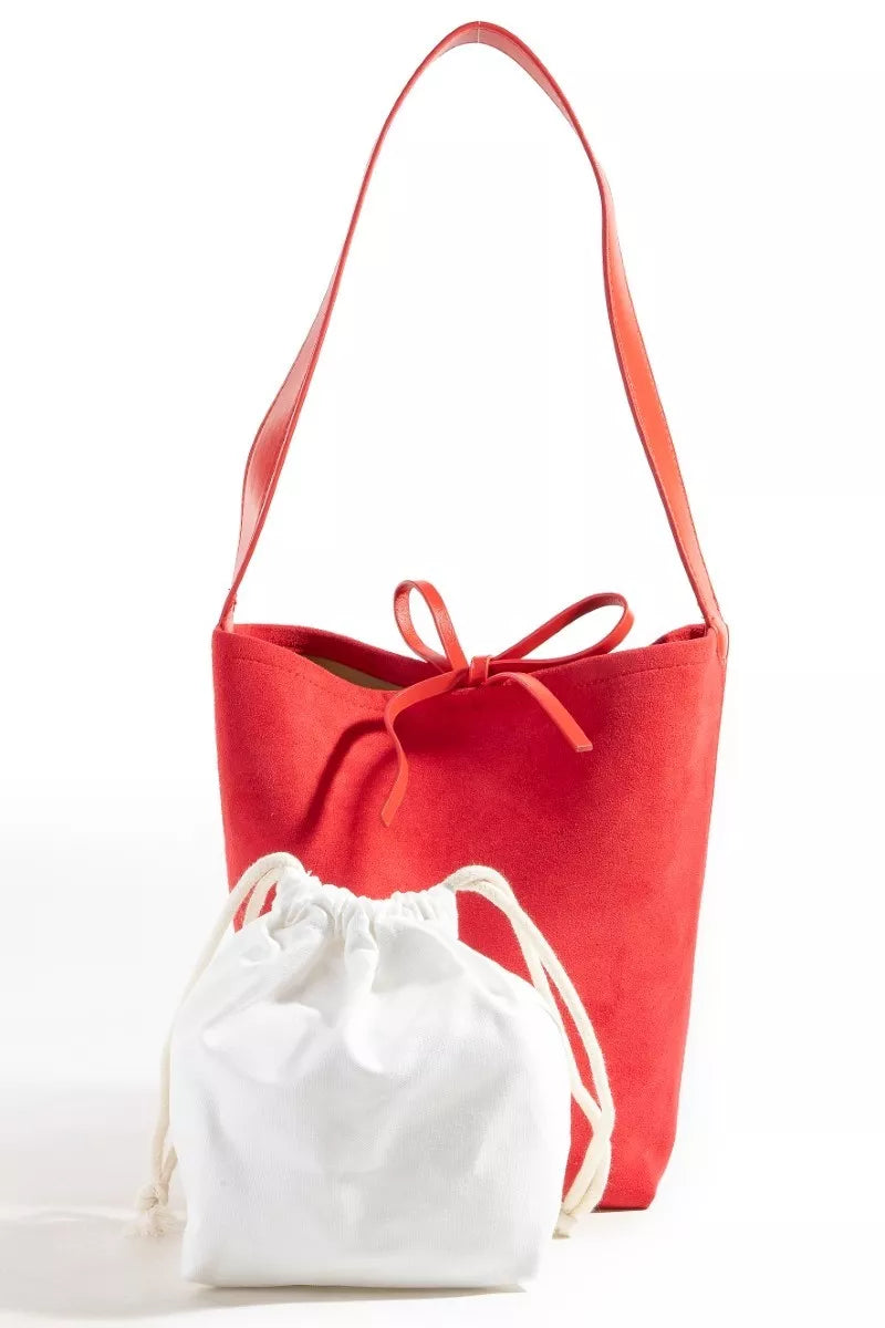 Red tote bag with a white drawstring bag on a white background