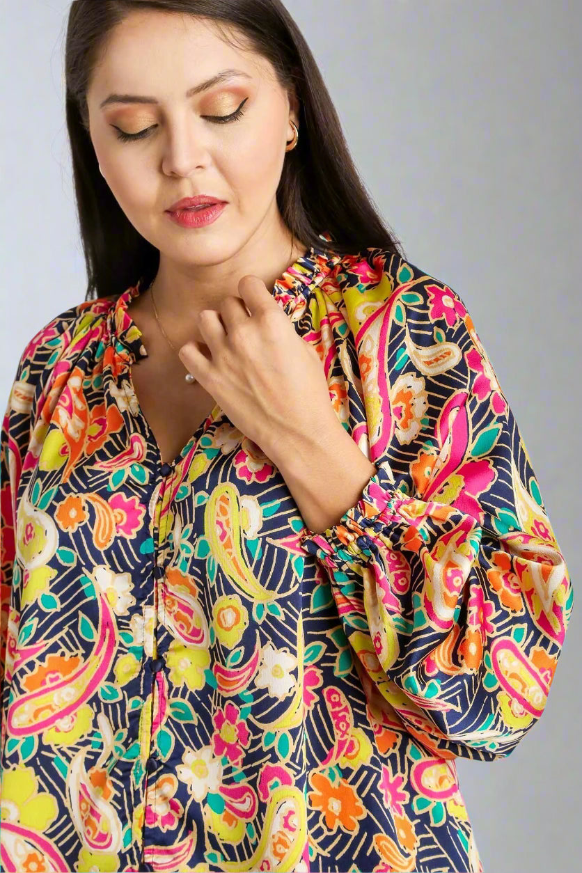 Woman wearing a colorful patterned blouse