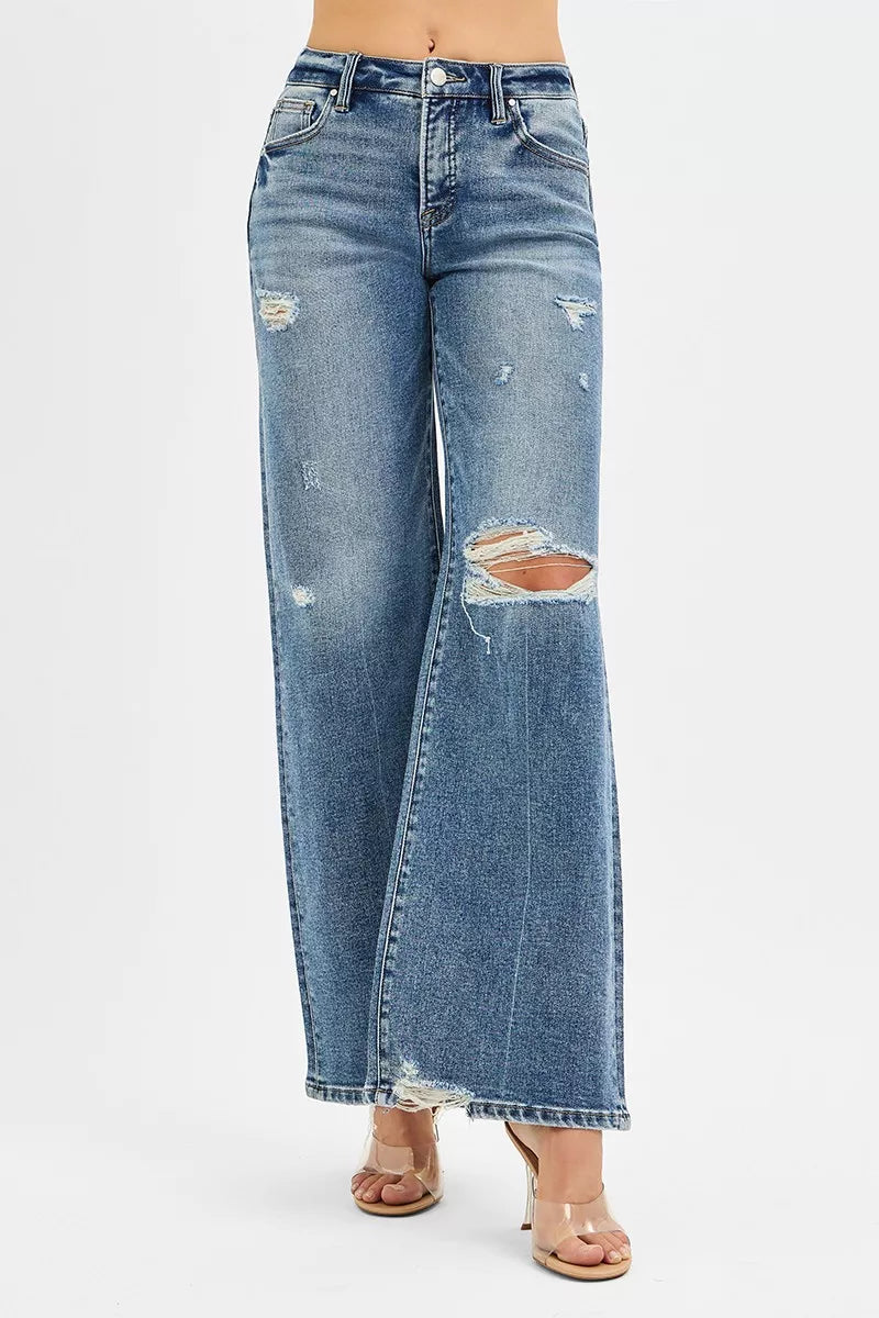 Distressed blue jeans on a white background