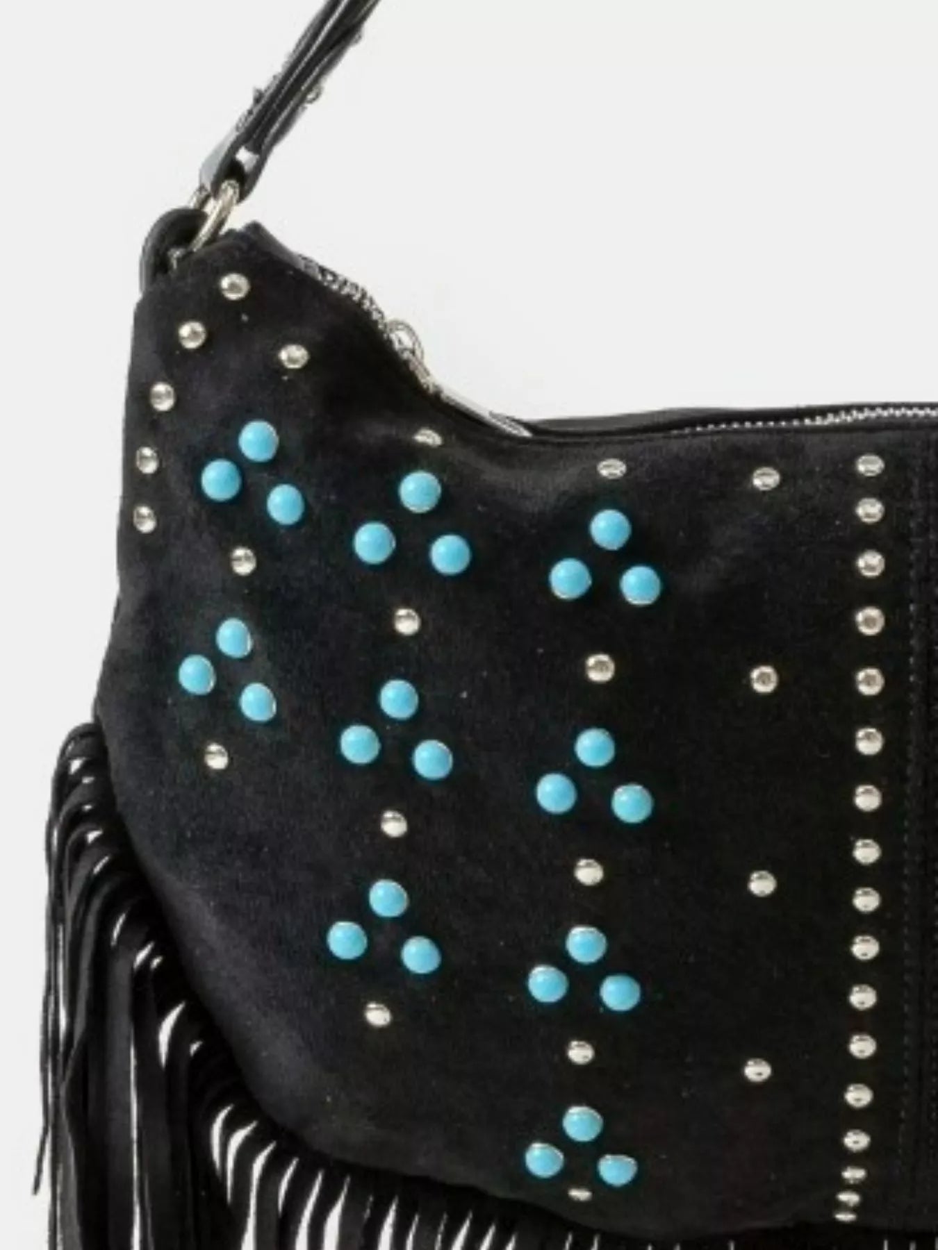 Black handbag with blue studs and silver fringe on a white background