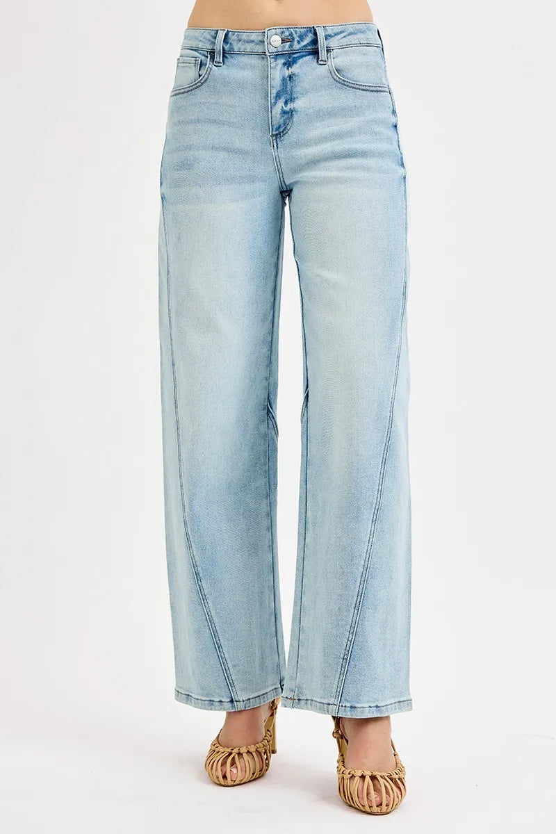 Light blue jeans worn by a person on a white background