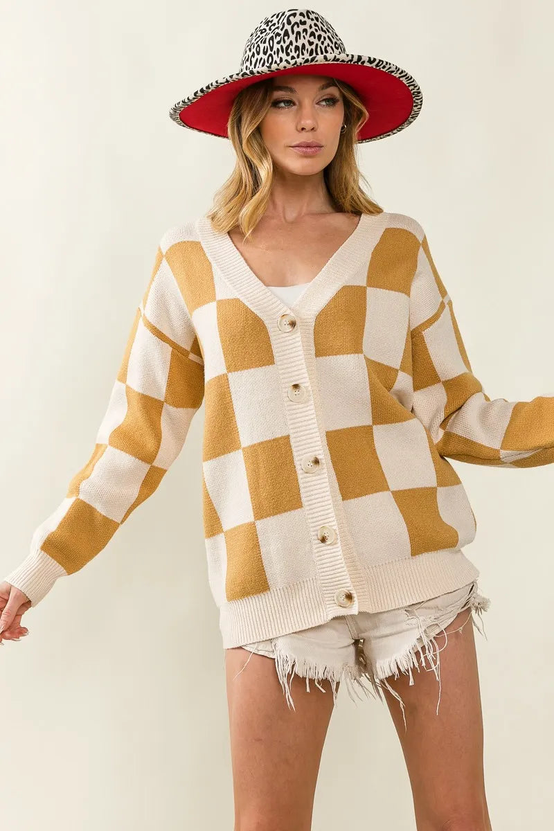 Woman wearing a checkered cardigan, shorts, and a leopard print hat on a white background