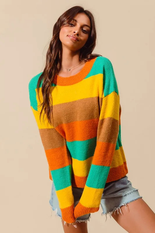 Woman wearing a colorful striped sweater against a beige background