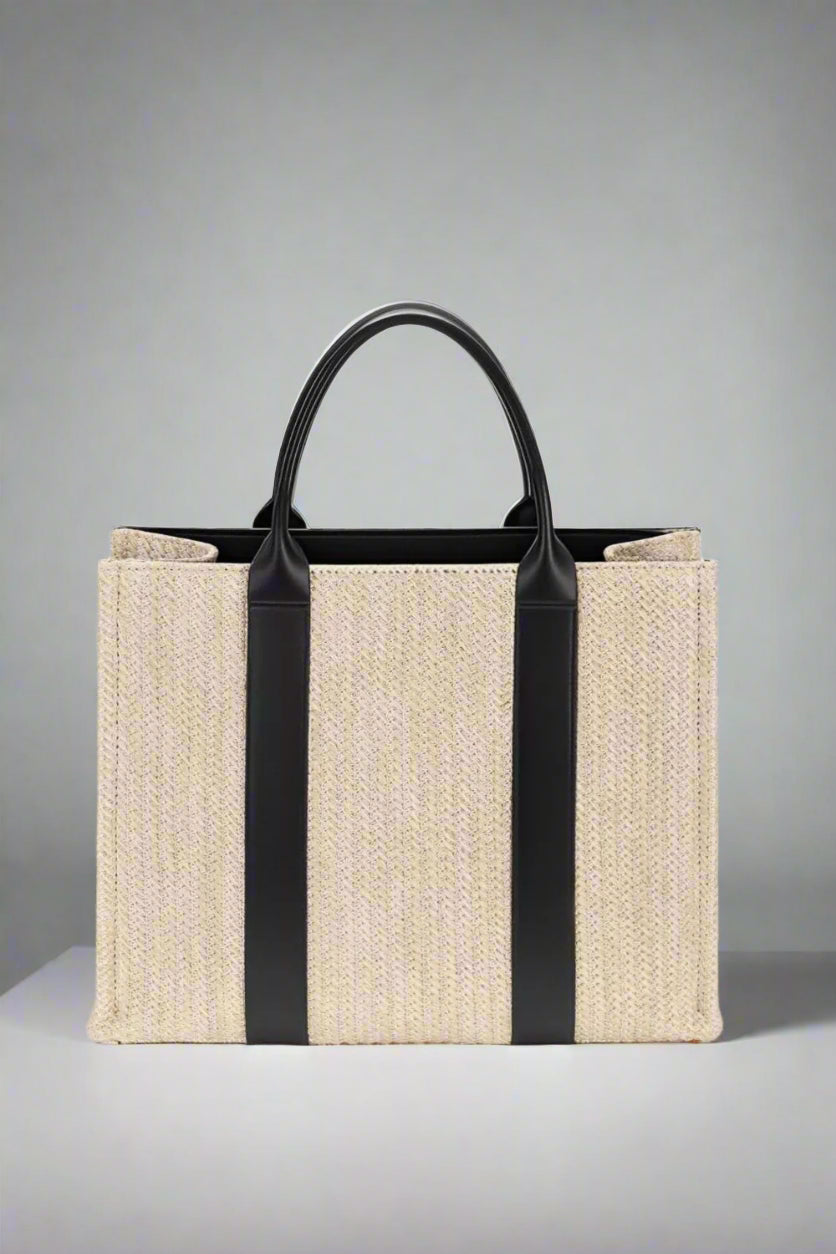 Beige tote bag with black straps on a white background