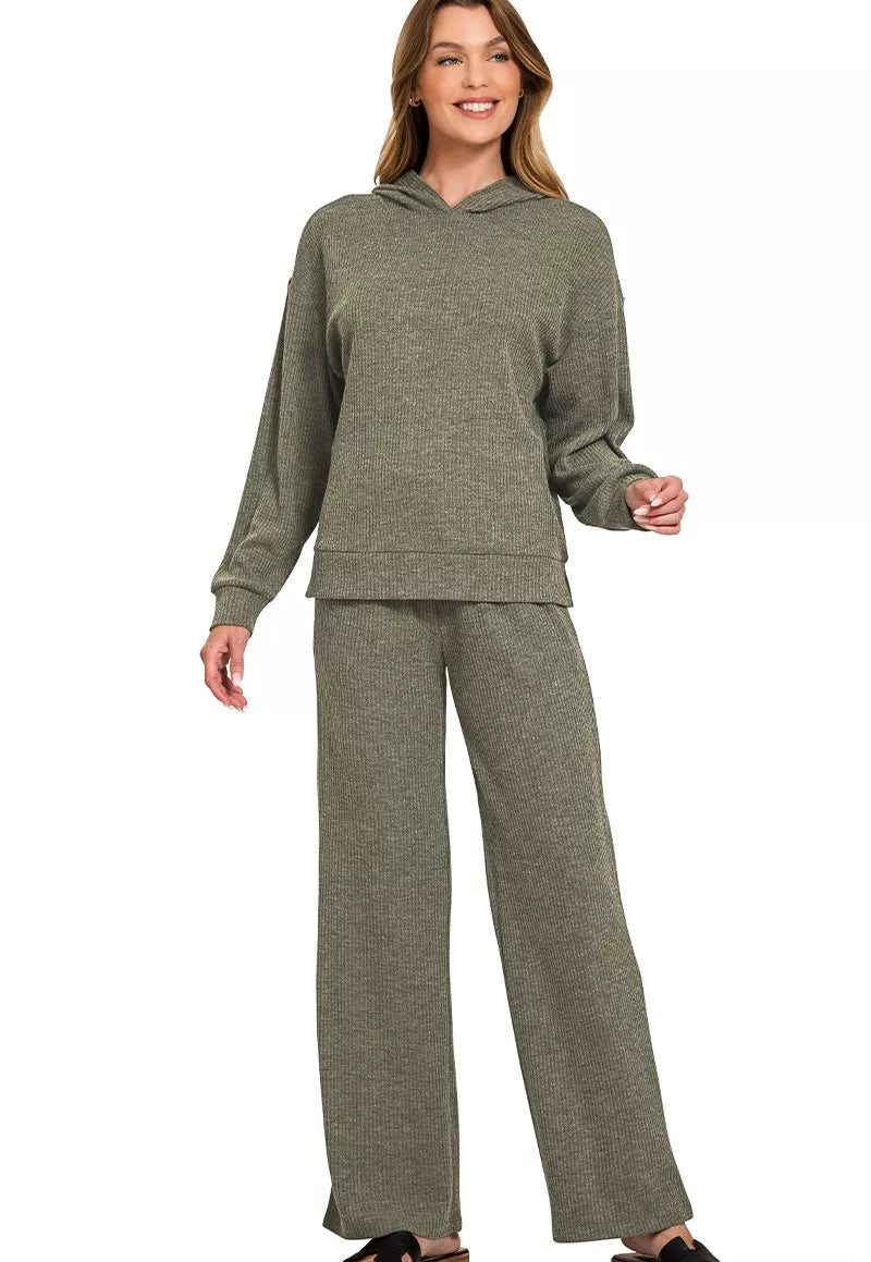 Woman wearing a green hoodie and pants set on a white background