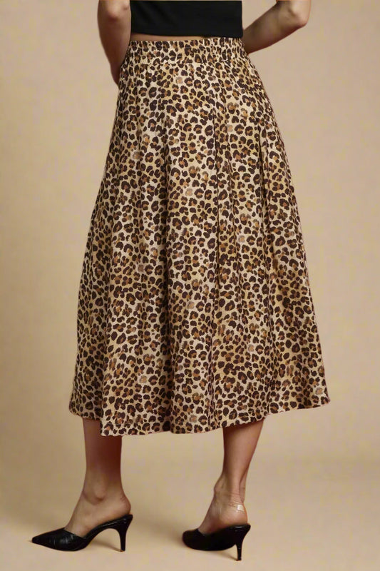 Leopard print skirt worn by a person on a beige background