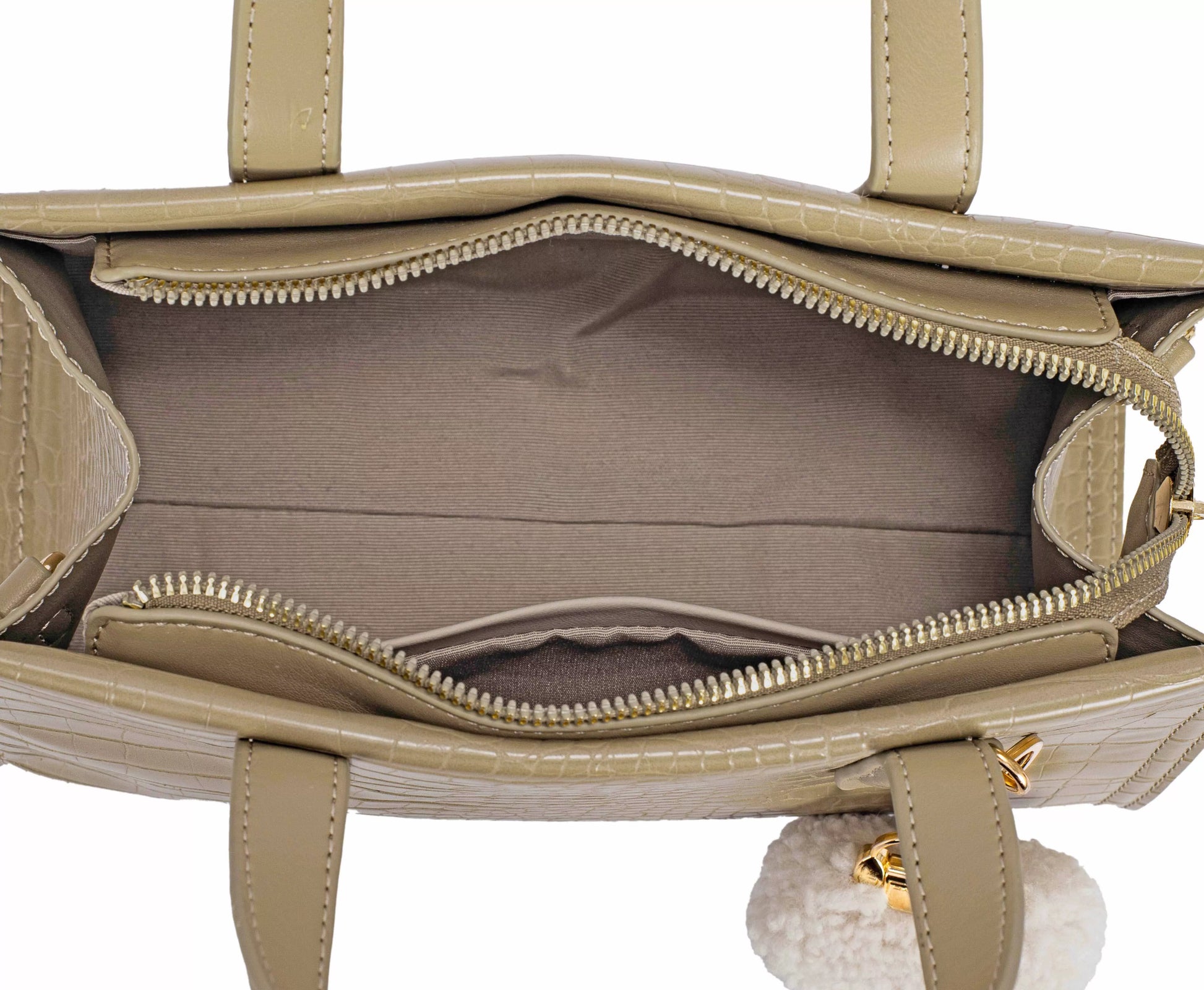 Beige handbag with gold zipper and handle on a white background