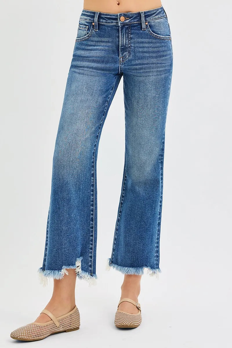 Blue jeans with frayed hems on a white background